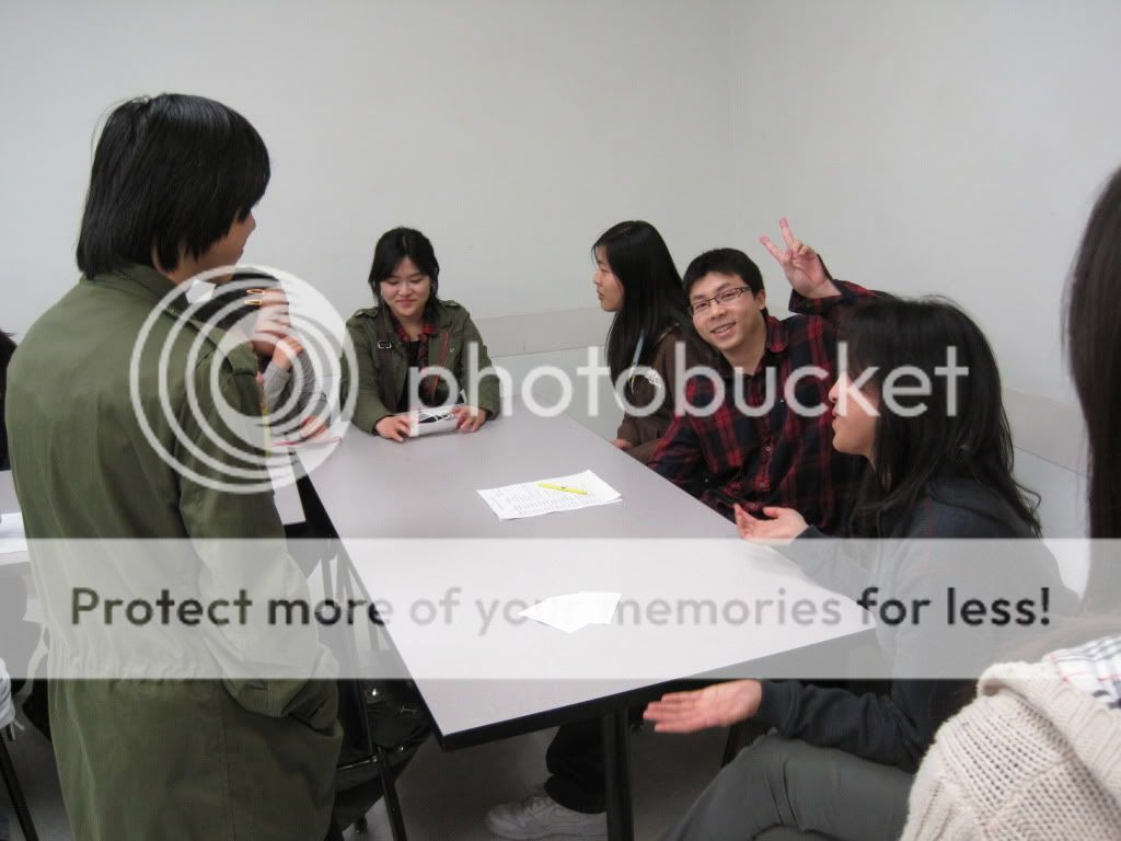 The Chinese group smiles for a picture, but over half of them are too focused on the stories at hand.